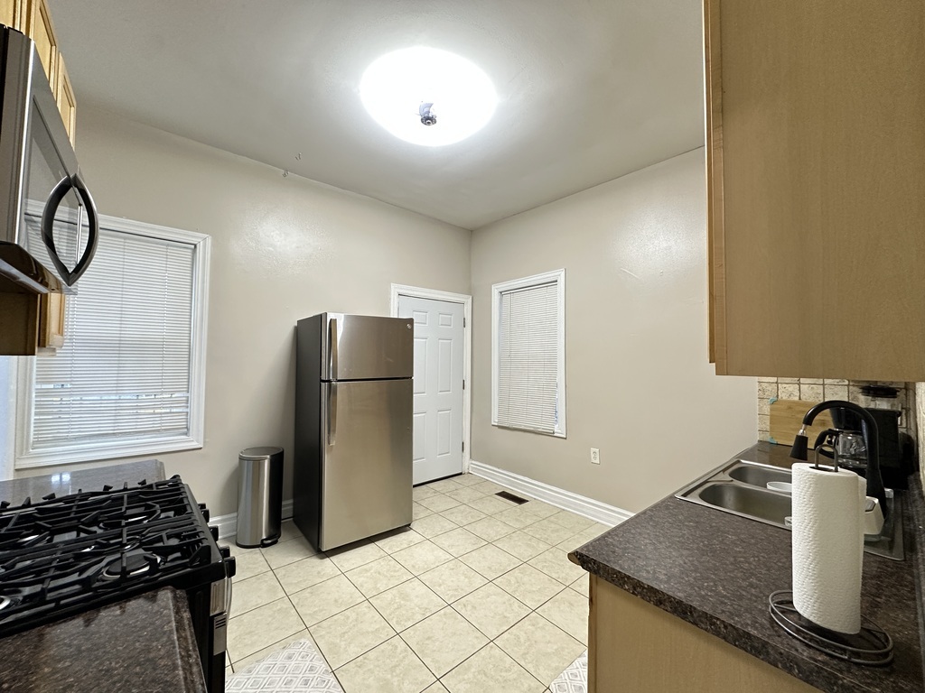 720 North Elizabeth Street, Unit 2 Chicago, IL 60642 - Photo 5 of 20 a kitchen with a refrigerator and a stove top oven