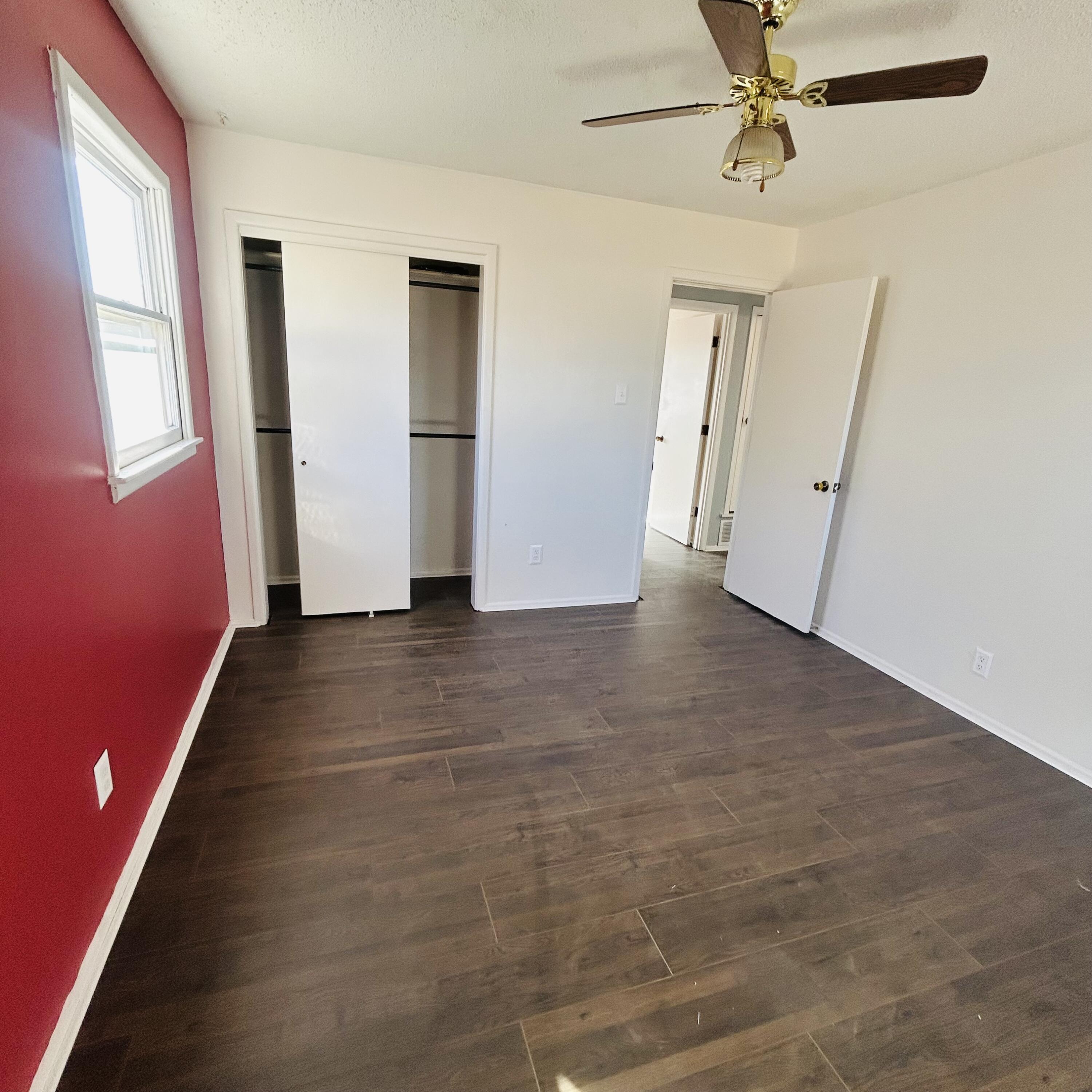 1918 71st Street Lubbock, TX 79412 - Photo 14 of 25 a view of a livingroom with wooden floor and a ceiling fan
