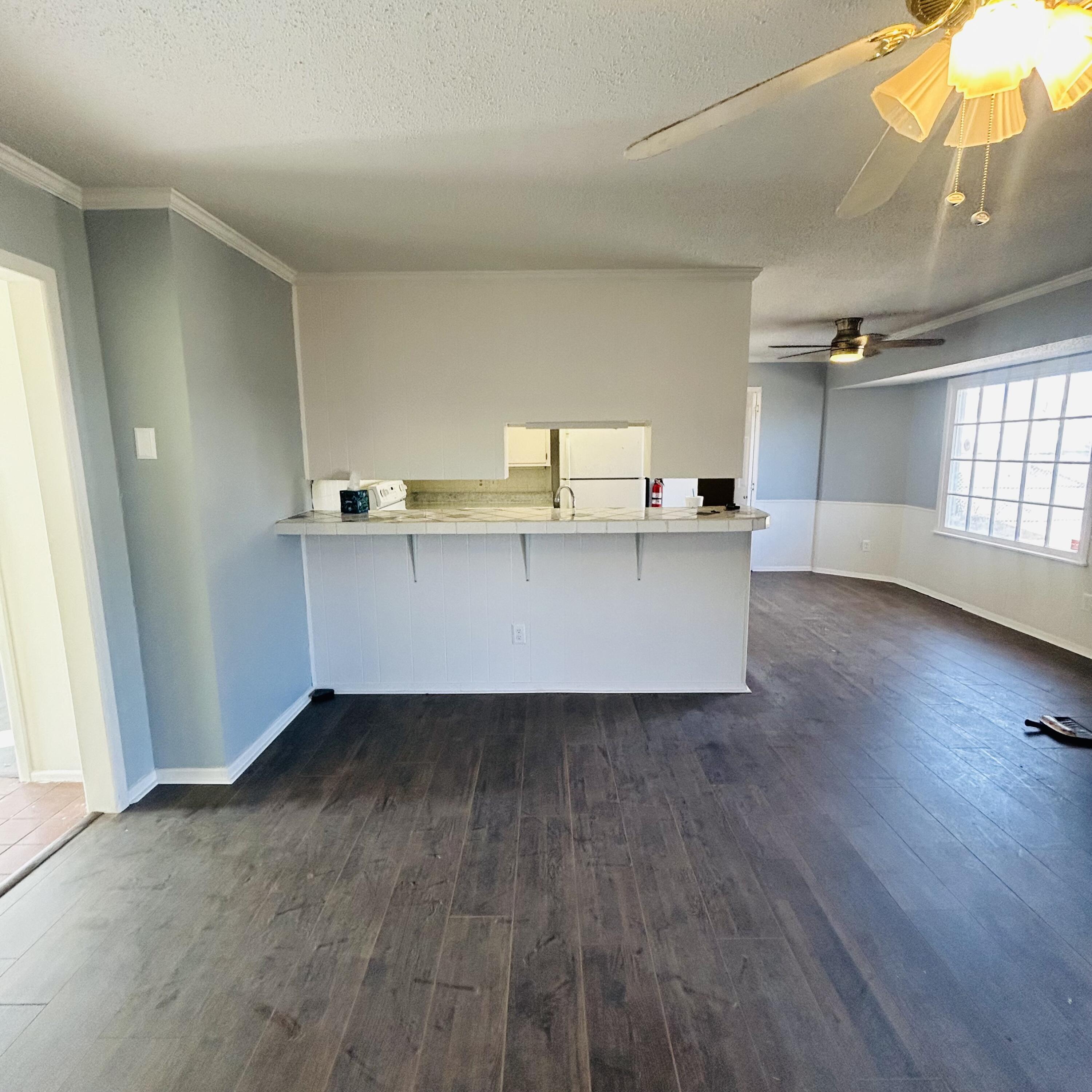 1918 71st Street Lubbock, TX 79412 - Photo 19 of 25 a view of a kitchen with wooden floor and electronic appliances