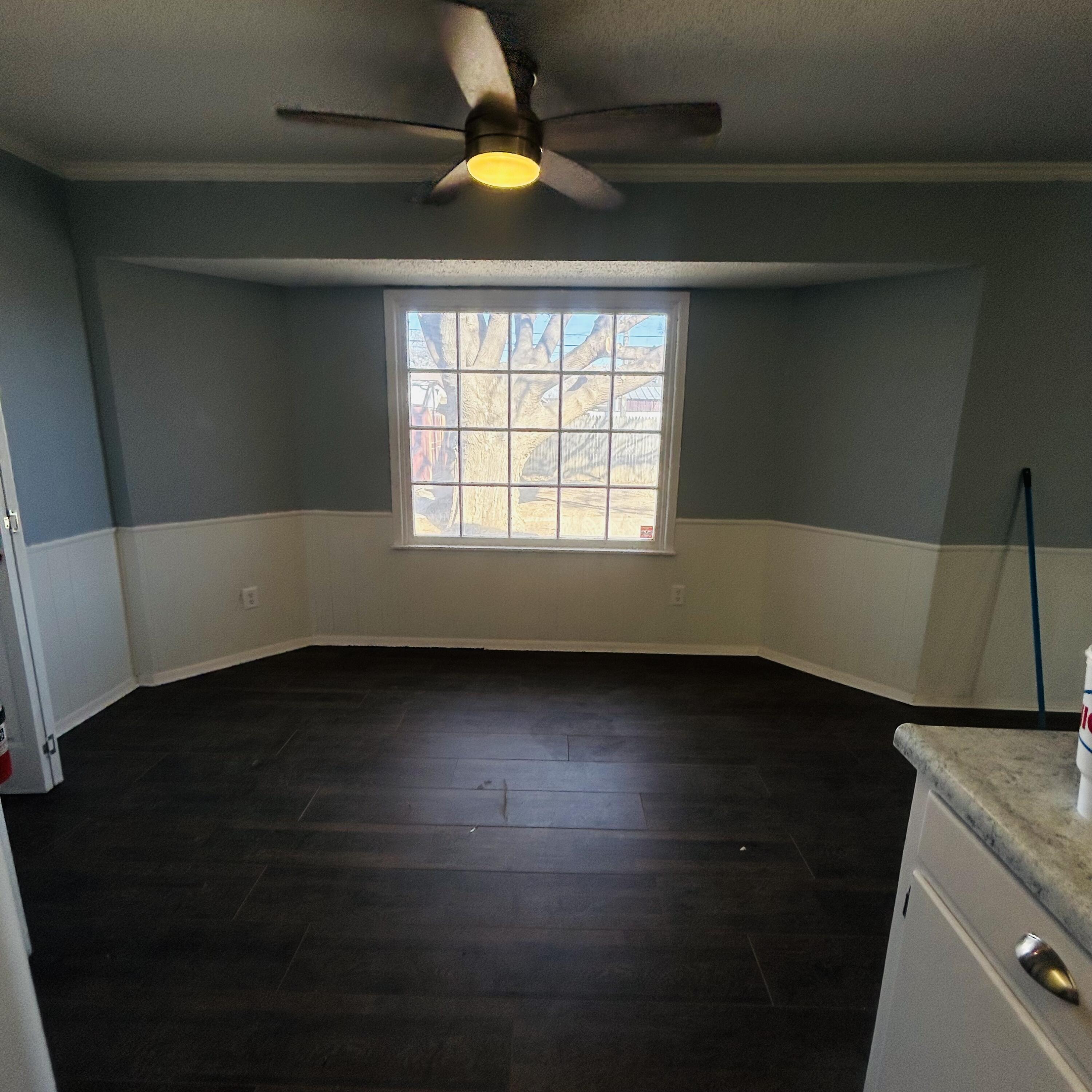 1918 71st Street Lubbock, TX 79412 - Photo 3 of 25 an empty room with wooden floor and windows