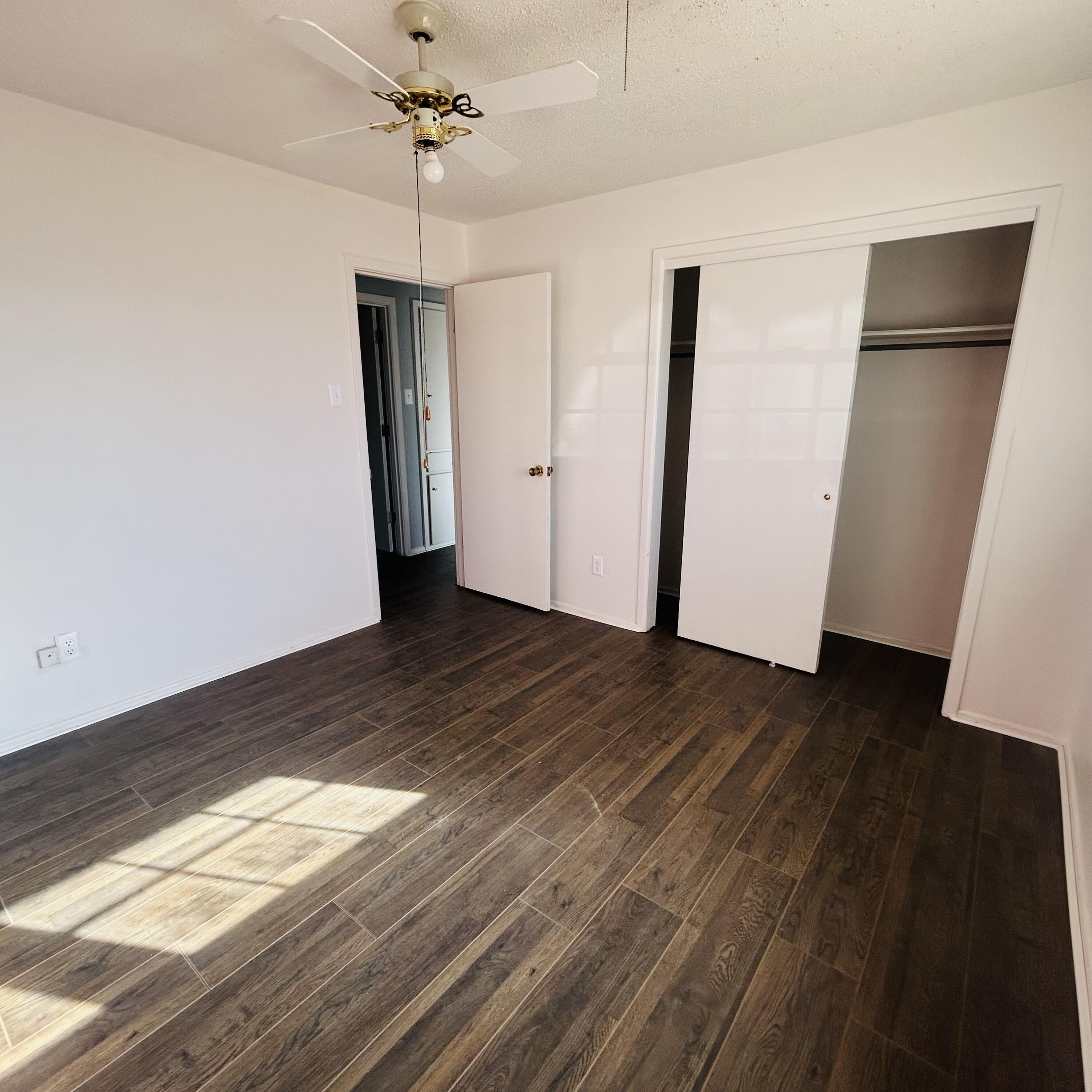 1918 71st Street Lubbock, TX 79412 - Photo 6 of 25 a view of empty room with wooden floor and fan