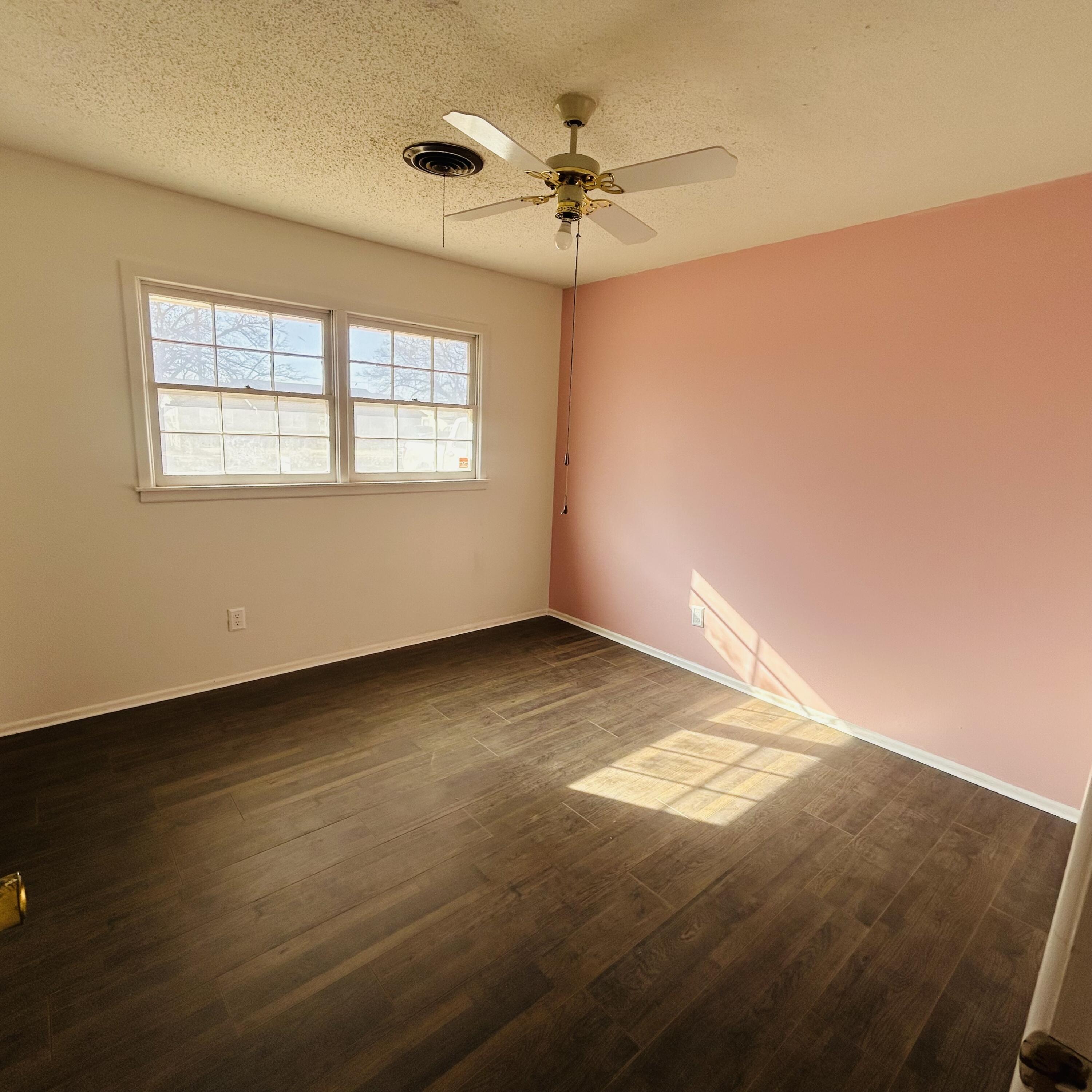 1918 71st Street Lubbock, TX 79412 - Photo 7 of 25 a view of an empty room with a window