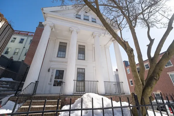a view of a large building with a tree