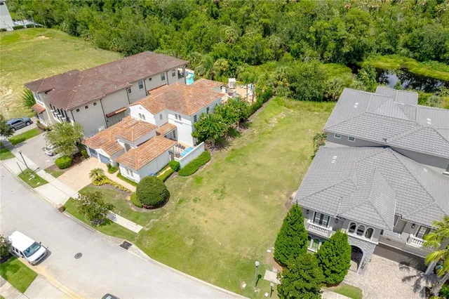 an aerial view of residential houses with outdoor space