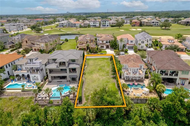 an aerial view of residential houses with outdoor space and river