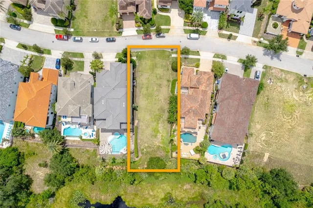 an aerial view of residential house with outdoor space and parking