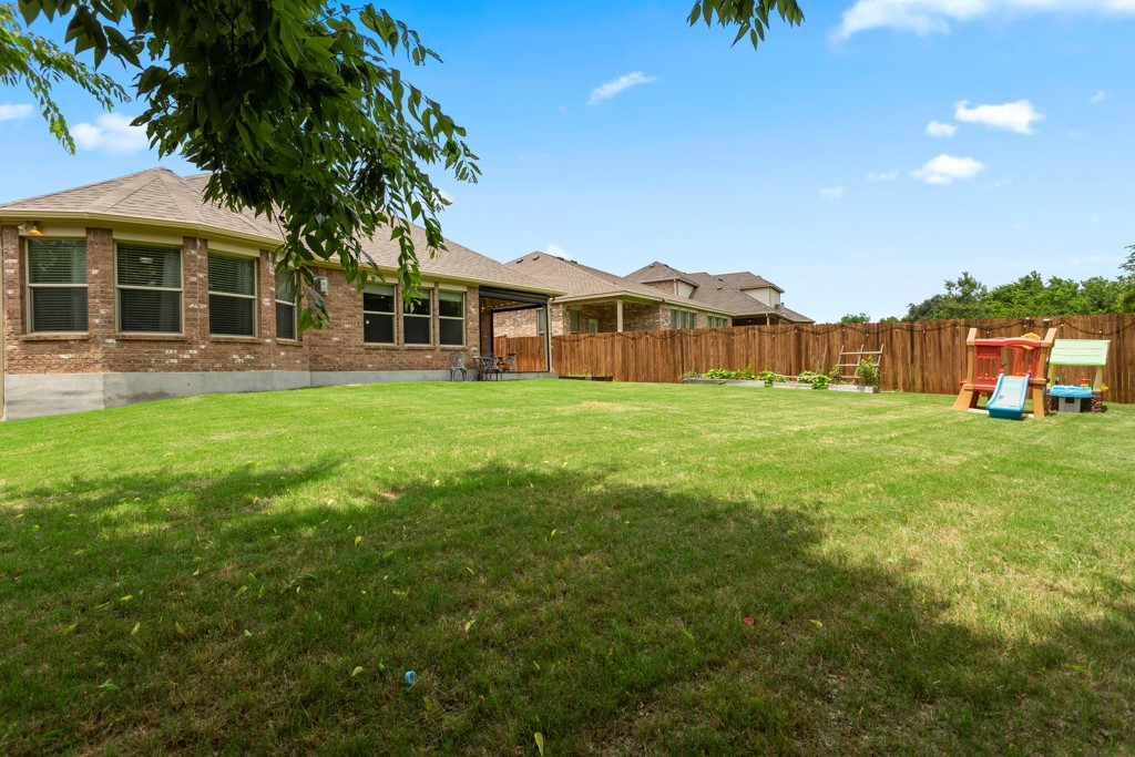 1916 Elaina Loop Leander, TX 78641 - Photo 23 of 23 a front view of a house with a yard