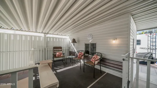 a kitchen with white cabinets and black appliances