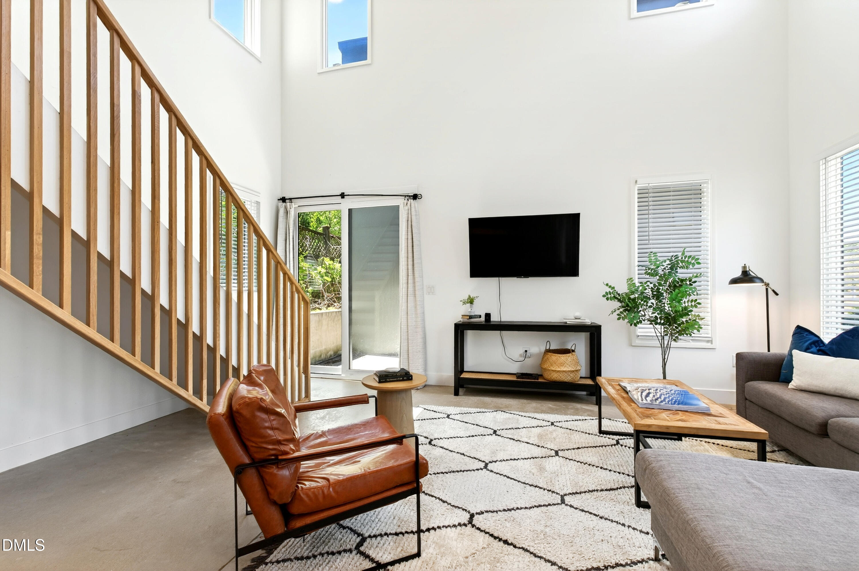 2159 Mayview Road, Unit B Raleigh, NC 27607 - Photo 12 of 50 a living room with furniture a flat screen tv and a fireplace