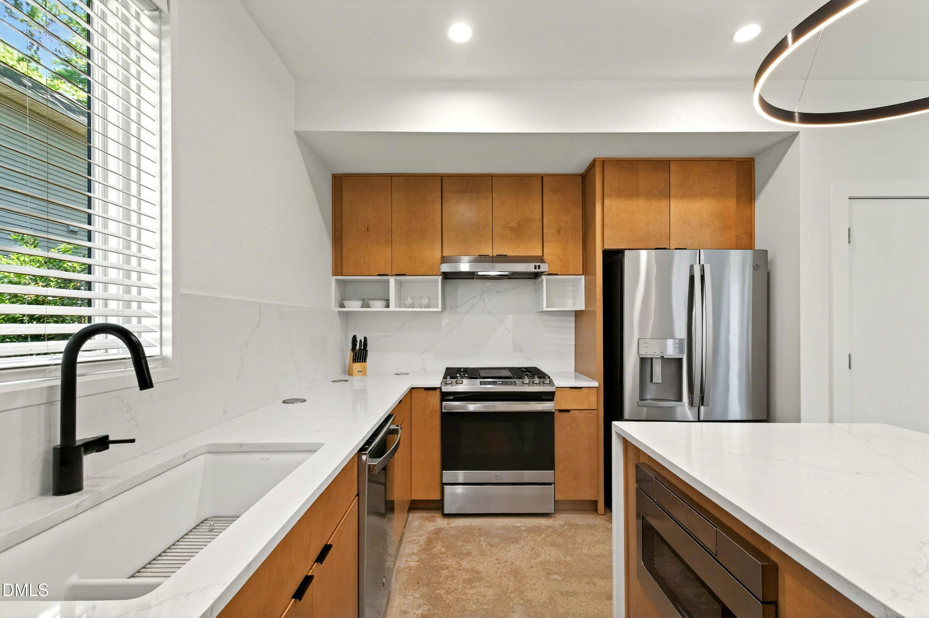 2159 Mayview Road, Unit B Raleigh, NC 27607 - Photo 19 of 50 a kitchen with kitchen island a sink appliances and cabinets