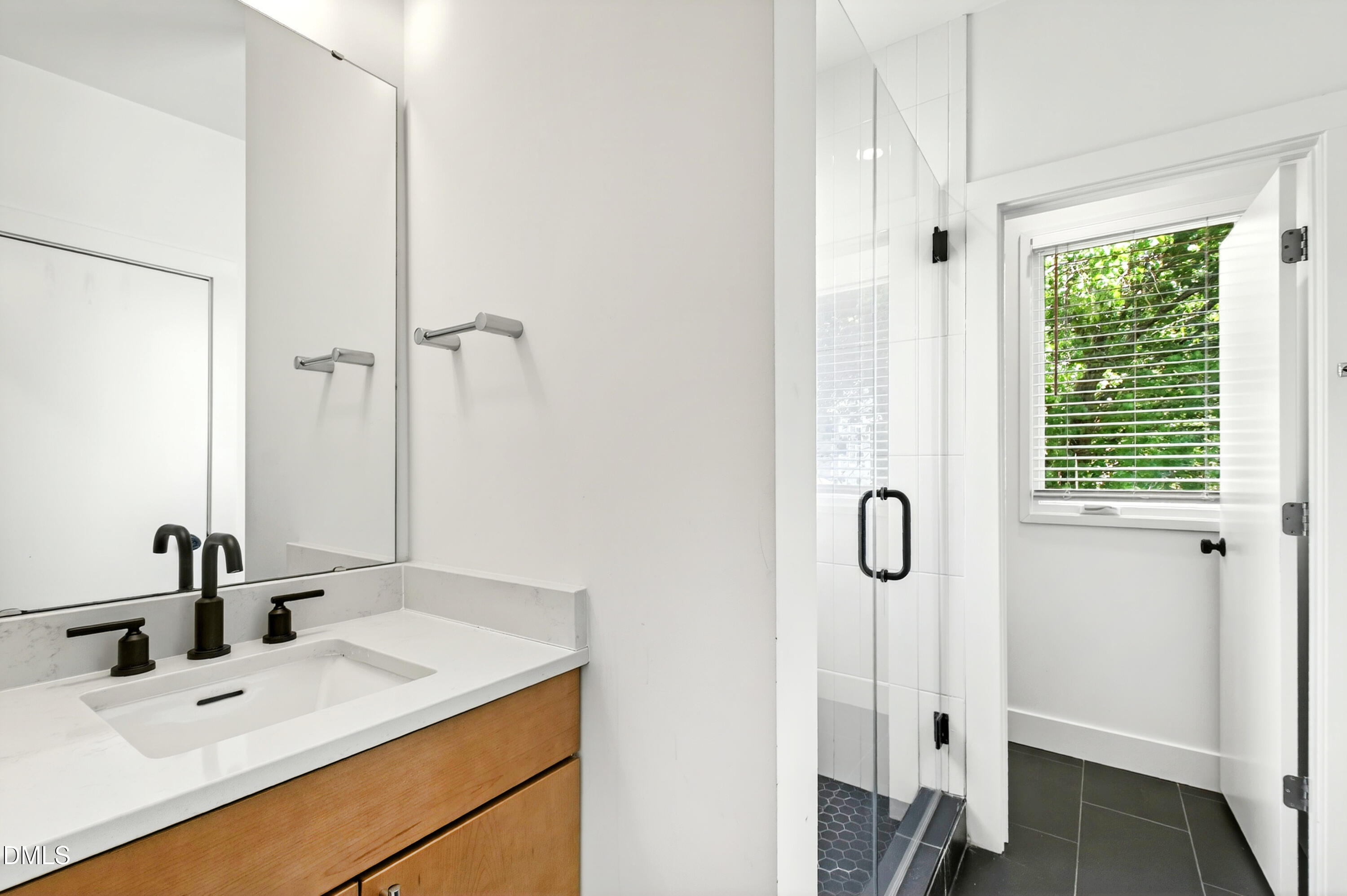 2159 Mayview Road, Unit B Raleigh, NC 27607 - Photo 26 of 50 a bathroom with a granite countertop sink a mirror and shower
