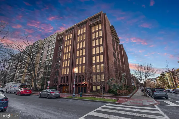 a building exterior with parked cars