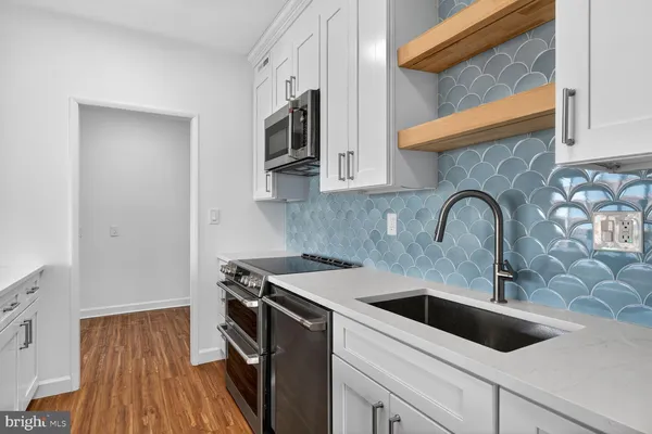 a view of a kitchen sink and a microwave