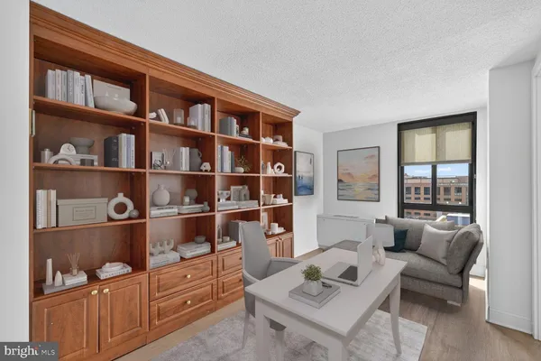 a living room with furniture cabinets and a rug