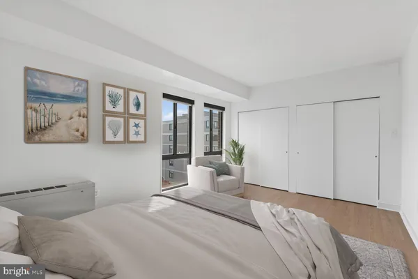 a bedroom with a bed and a painting on the wall