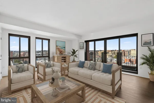 a living room with furniture and a large window with outer view