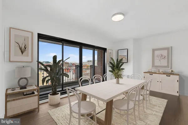 a view of a dining room with furniture window and wooden floor