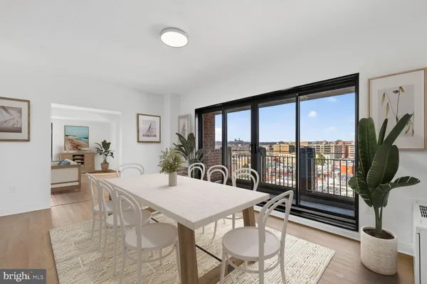 a view of a dining room with furniture window and wooden floor