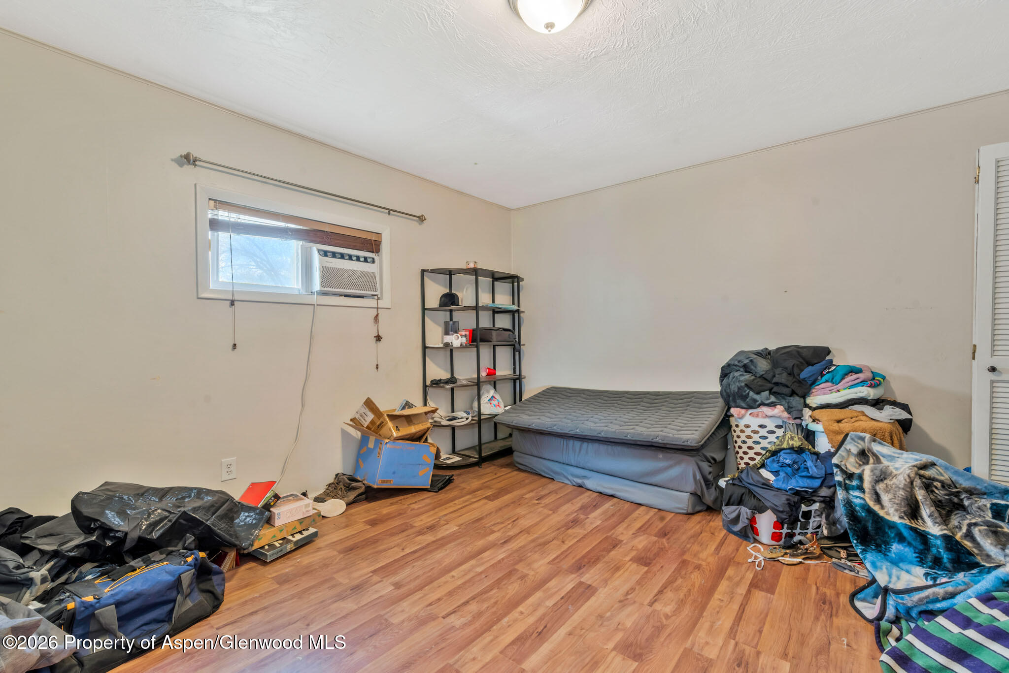 1141 Breeze Street Craig, CO 81625 - Photo 14 of 28 a bedroom with furniture and a wooden floor