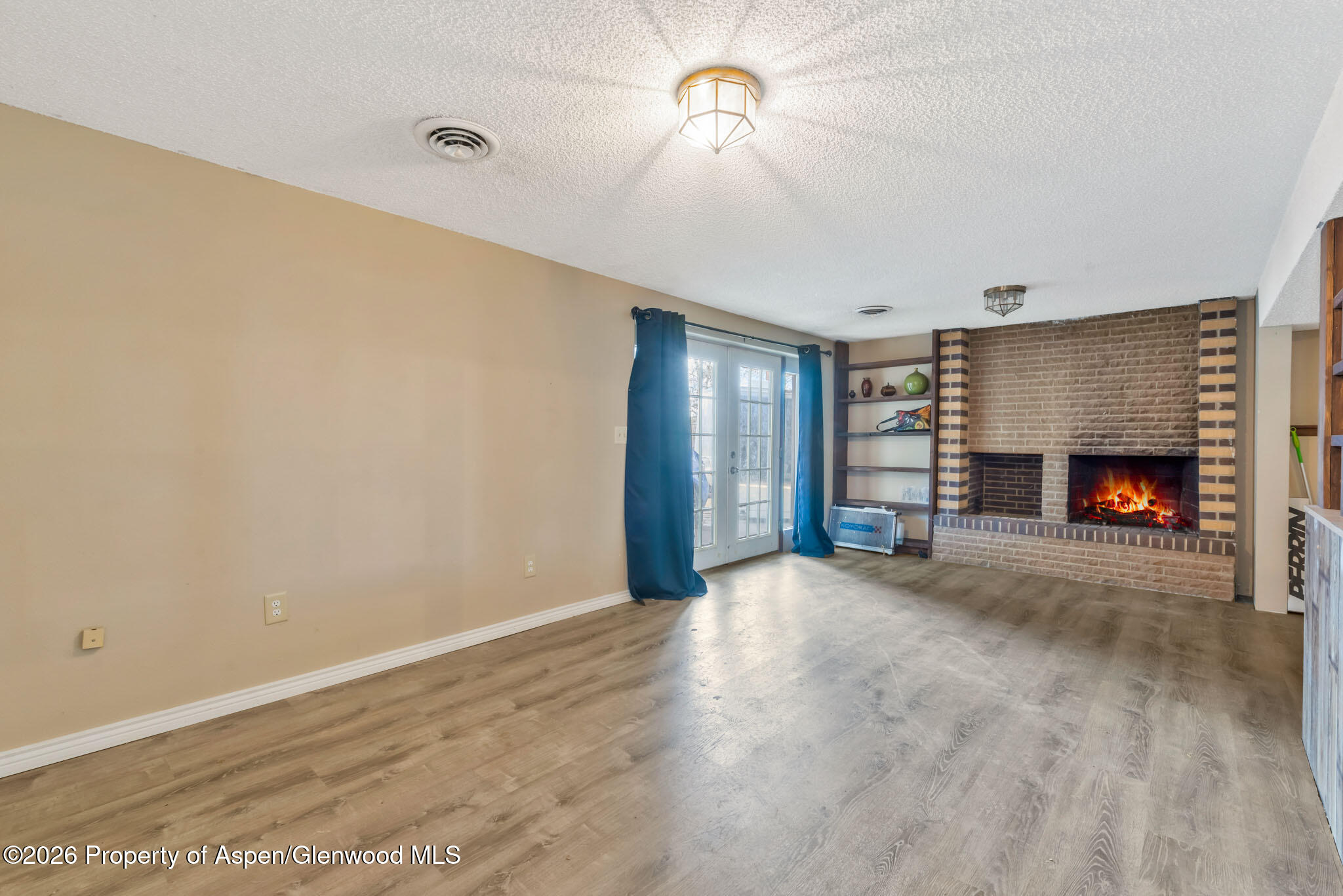 1141 Breeze Street Craig, CO 81625 - Photo 16 of 28 a view of empty room with fireplace and fan