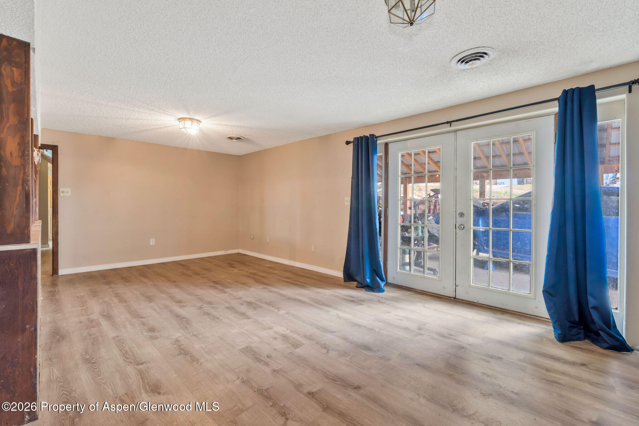 1141 Breeze Street Craig, CO 81625 - Photo 17 of 28 a view of an empty room with glass door
