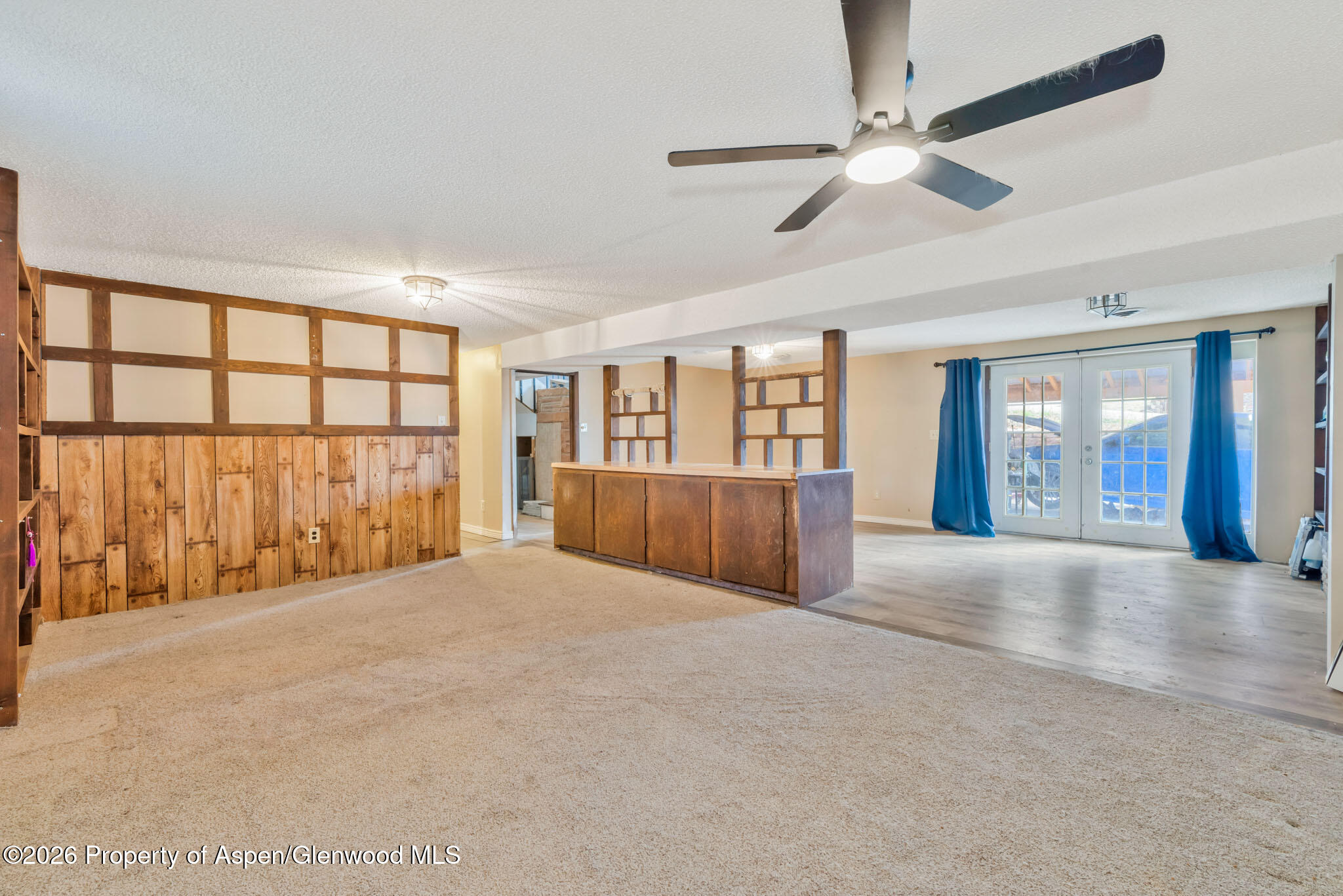 1141 Breeze Street Craig, CO 81625 - Photo 19 of 28 a view of an empty room with a window and a kitchen view