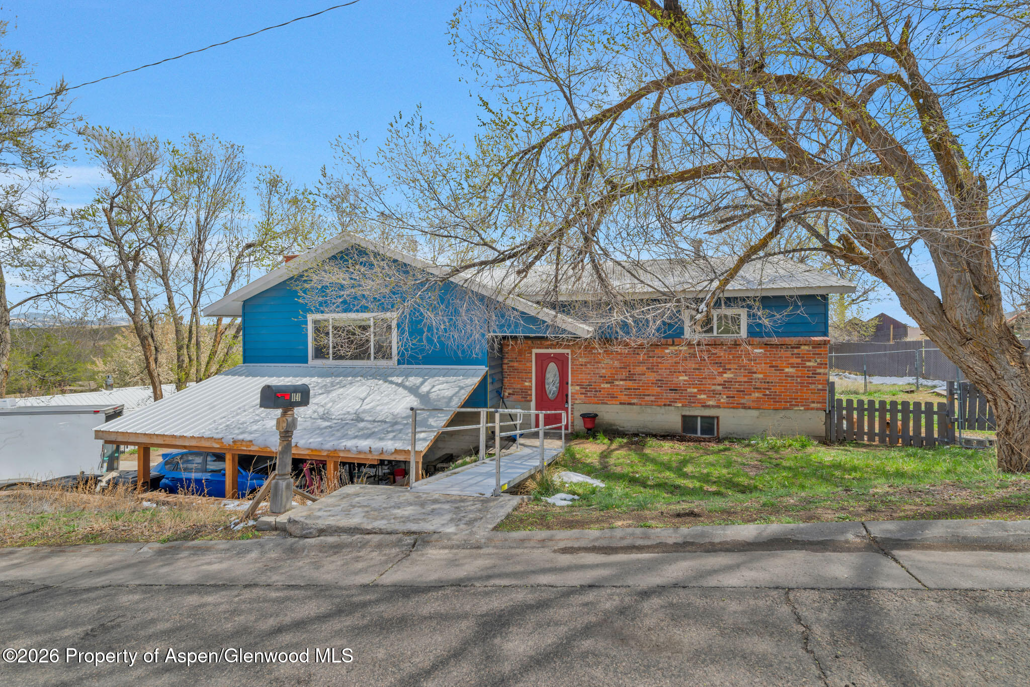 1141 Breeze Street Craig, CO 81625 - Photo 2 of 28 a front view of a house with a garden and trees