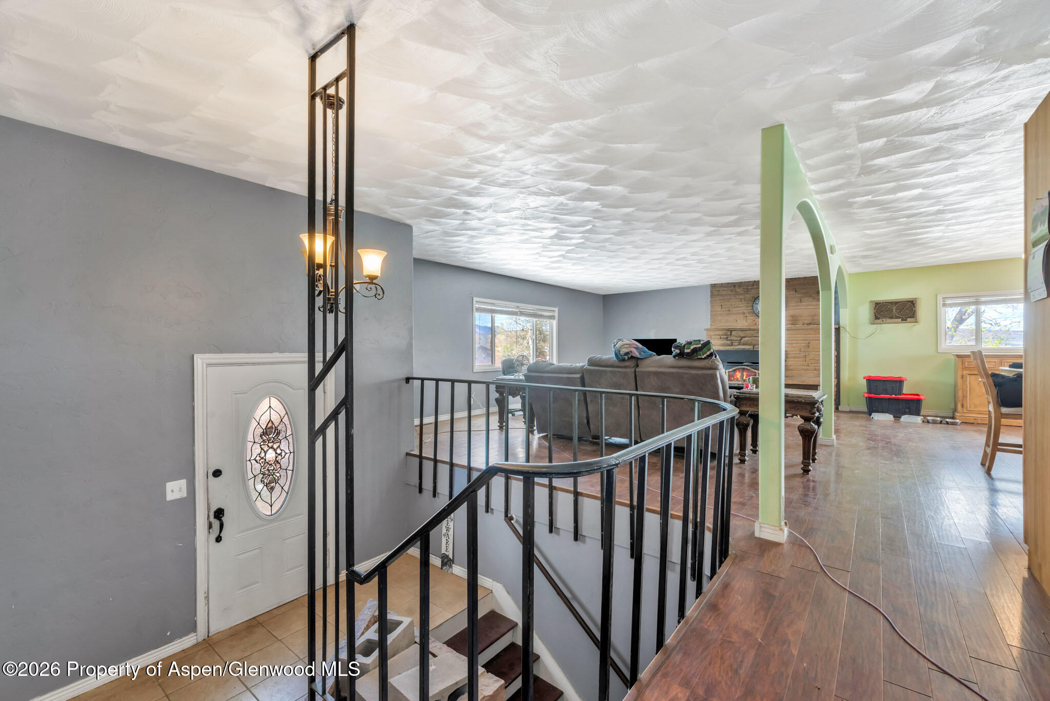 1141 Breeze Street Craig, CO 81625 - Photo 4 of 28 a view of a hallway with wooden floor and stairs