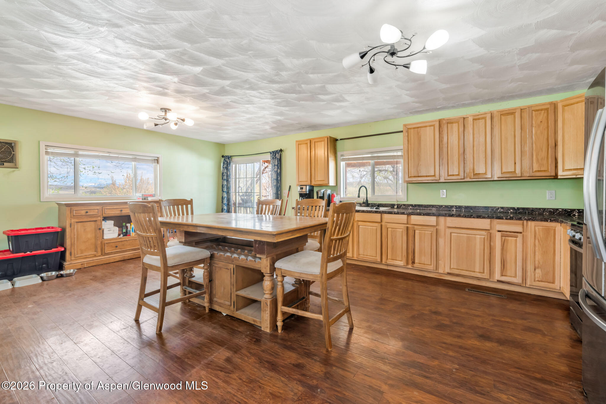 1141 Breeze Street Craig, CO 81625 - Photo 5 of 28 a kitchen with granite countertop wooden floors and white stainless steel appliances