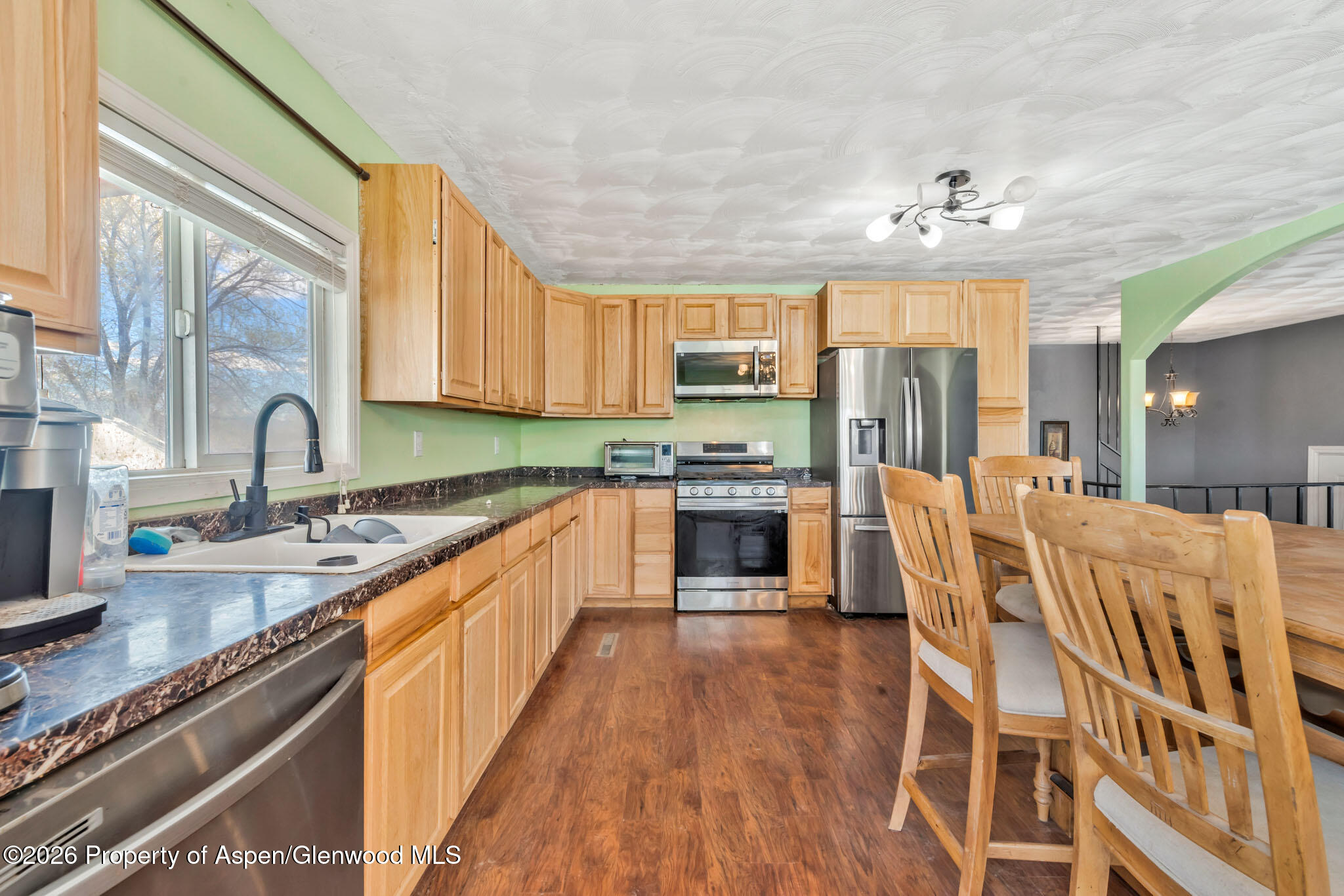 1141 Breeze Street Craig, CO 81625 - Photo 6 of 28 a large kitchen with stainless steel appliances sink microwave and stove