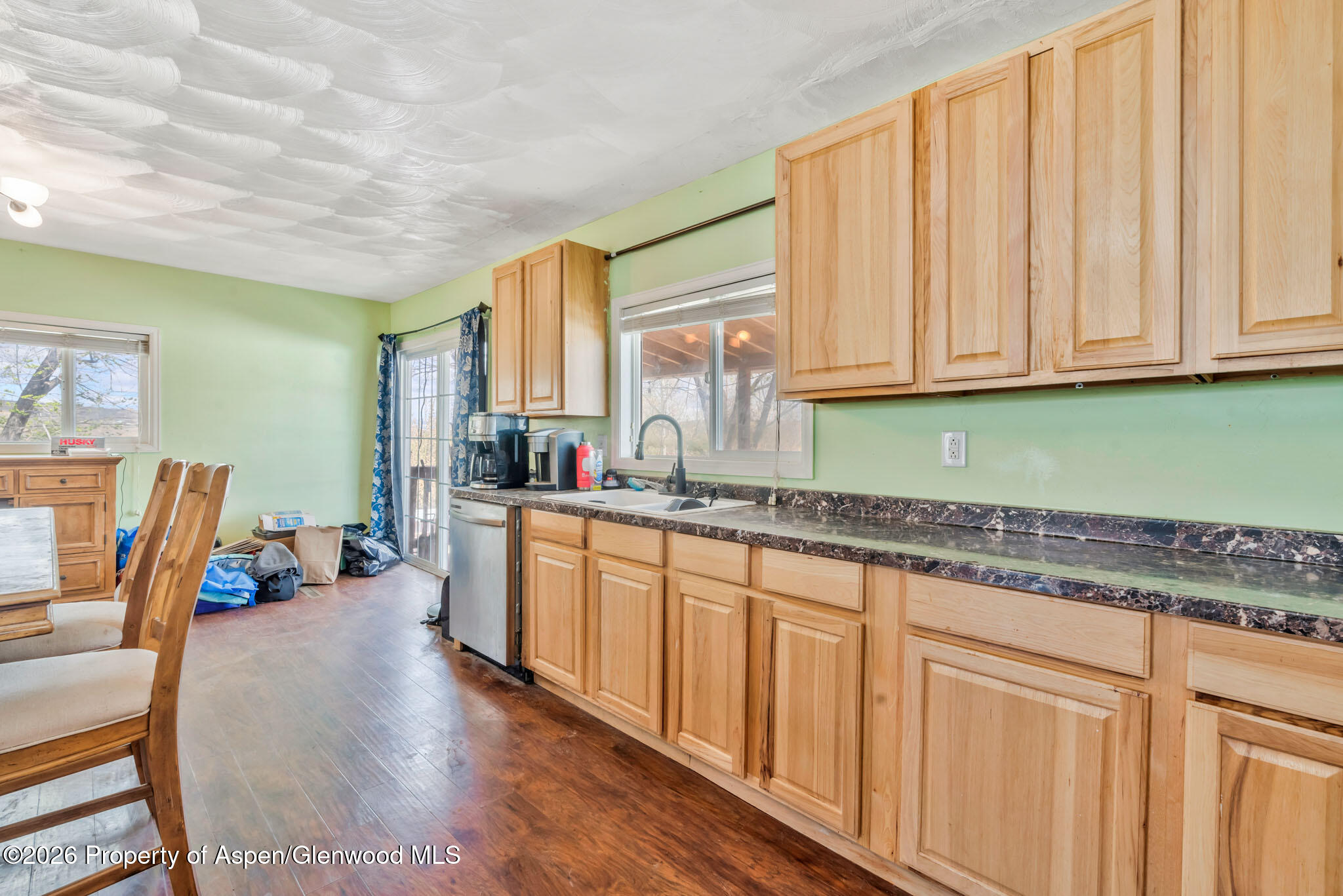1141 Breeze Street Craig, CO 81625 - Photo 7 of 28 a kitchen with large window a sink and cabinets