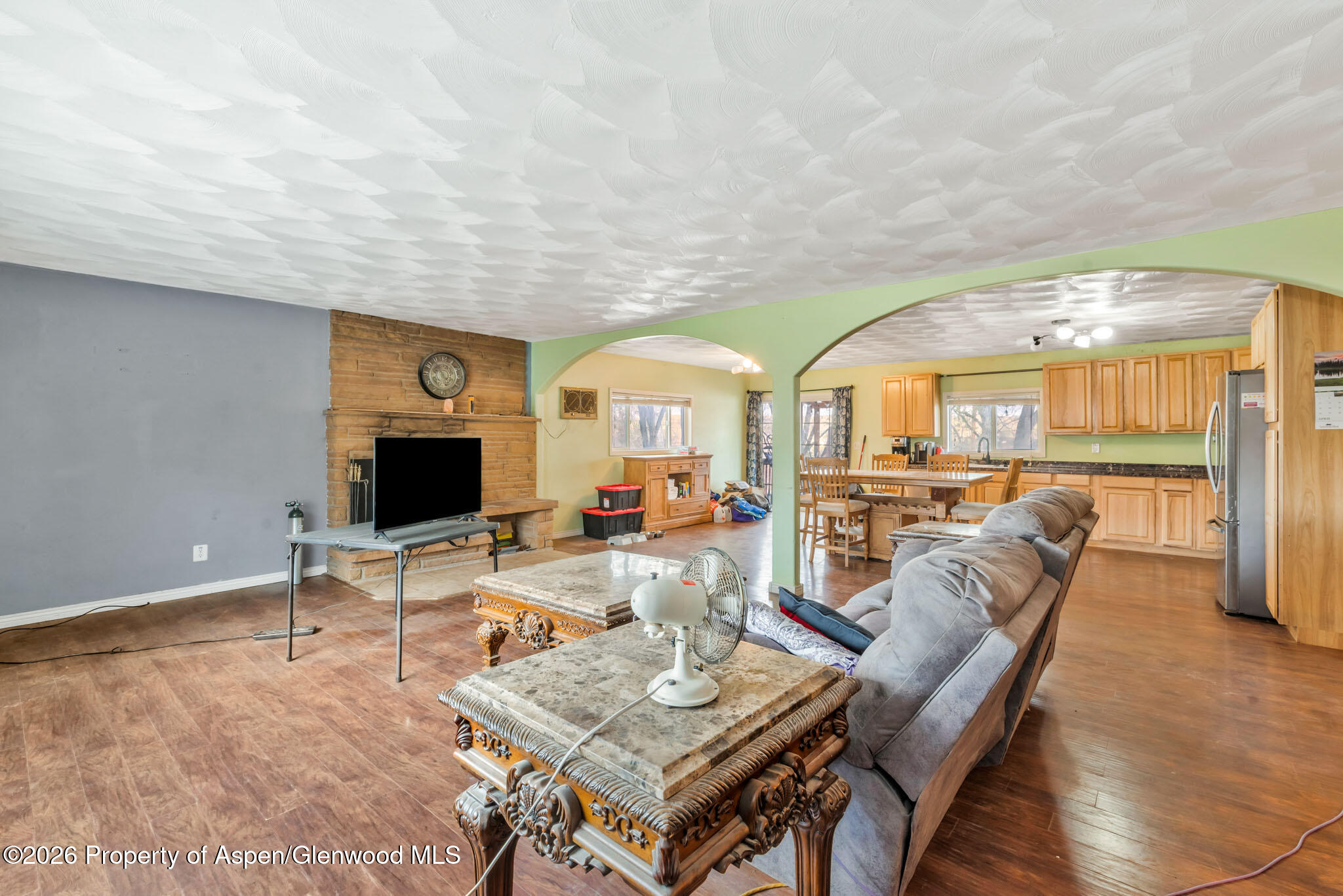 1141 Breeze Street Craig, CO 81625 - Photo 10 of 28 a living room with fireplace furniture and a flat screen tv