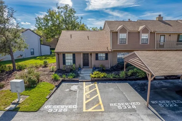 a front view of a house with a yard and potted plants
