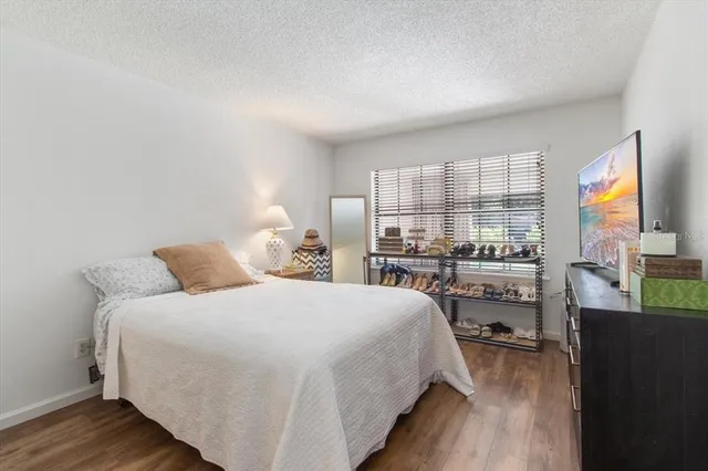 a bedroom with a bed and a large window