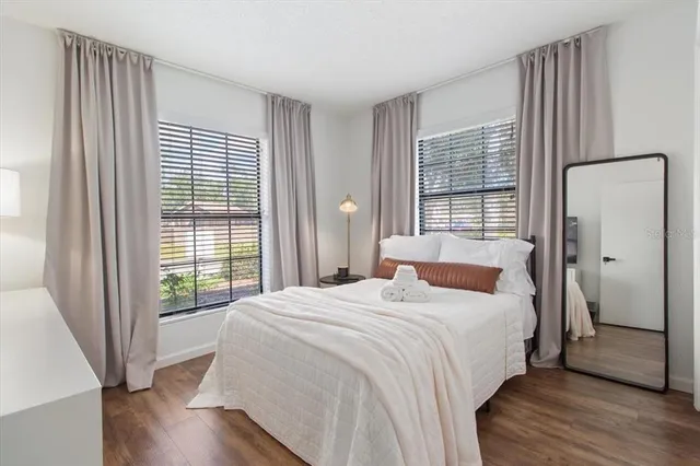 a bedroom with a bed and a large window