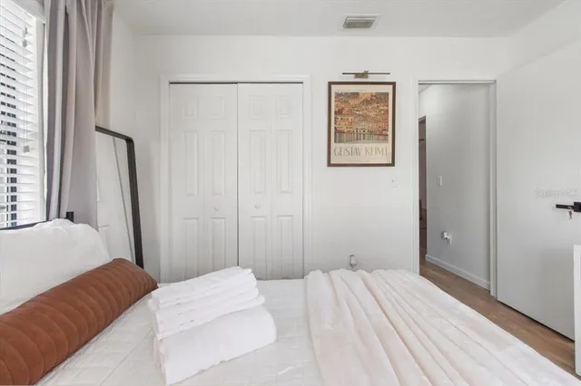 a bedroom with a bed and a window