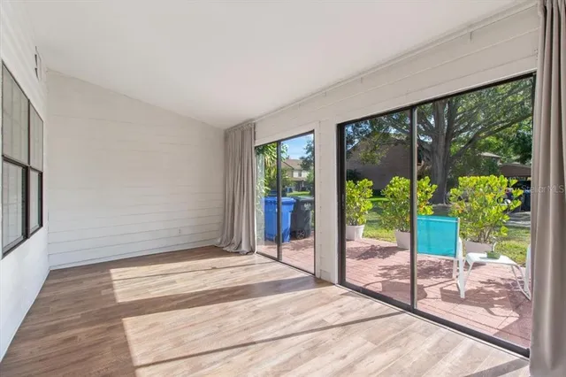a bedroom with a bed and glass door