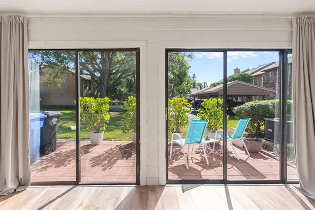 a view of a floor to ceiling window and wooden floor