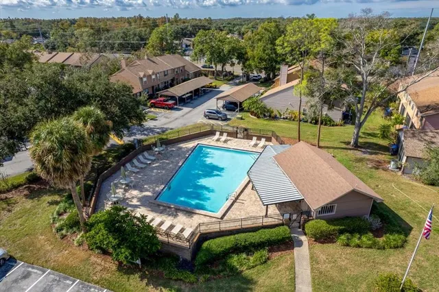 a view of a backyard and swimming pool