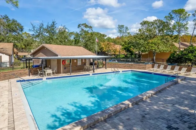a view of a house with swimming pool and sitting area