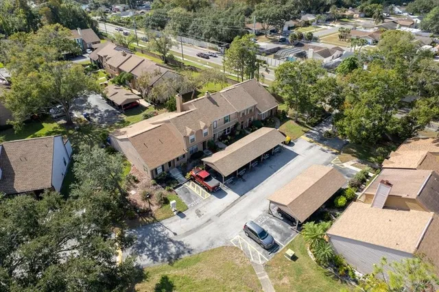 an aerial view of a house with a yard