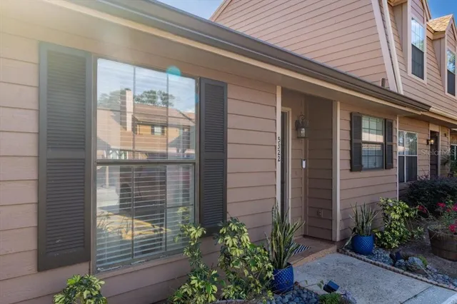 a view of yellow house with a potted plant on walls