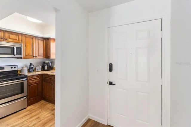 a kitchen with stainless steel appliances granite countertop a refrigerator and a stove top oven