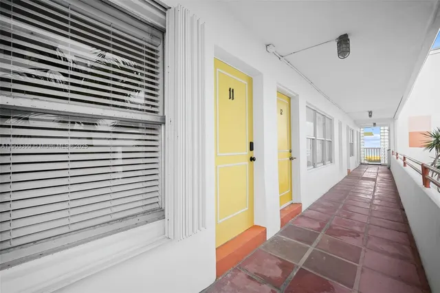 a view of a hallway with wooden cabinets