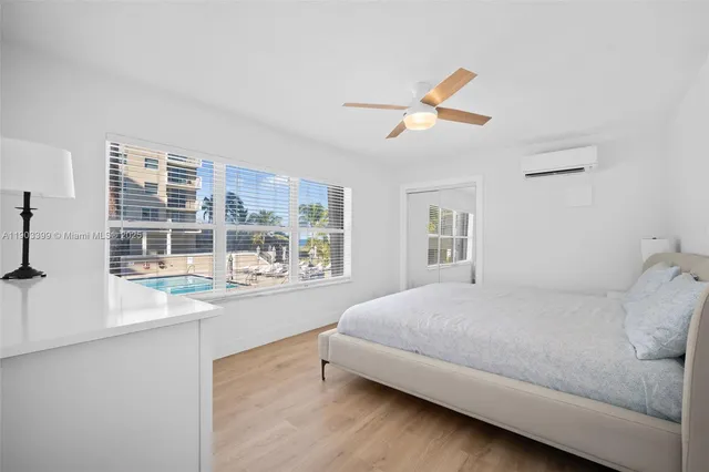 a bedroom with a large bed and a large window