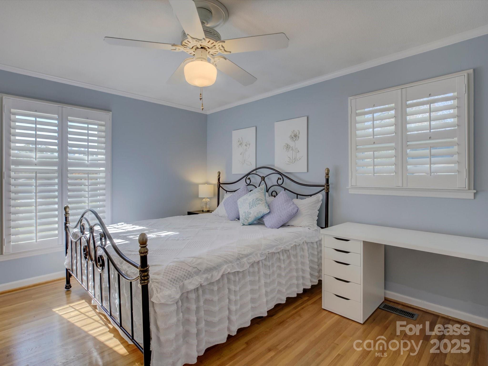 3409 Oak Tree Trail Matthews, NC 28105 - Photo 3 of 3 a bedroom with a bed next to a window with table and chair