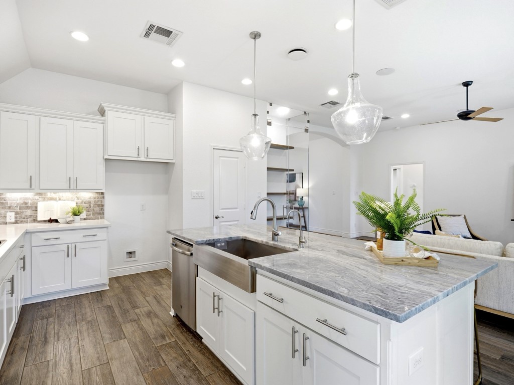 109 Lake Spring Circle Georgetown, TX 78633 - Photo 18 of 38 A well-appointed kitchen showcasing a spacious island with a farmhouse sink.