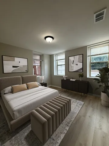 a bedroom with a large bed and a couch