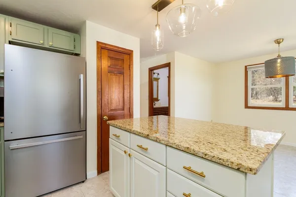 a kitchen with stainless steel appliances granite countertop a refrigerator and a sink