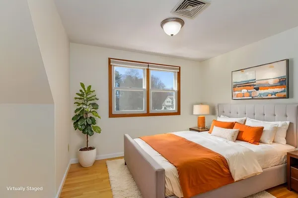 a bedroom with a bed and a potted plant